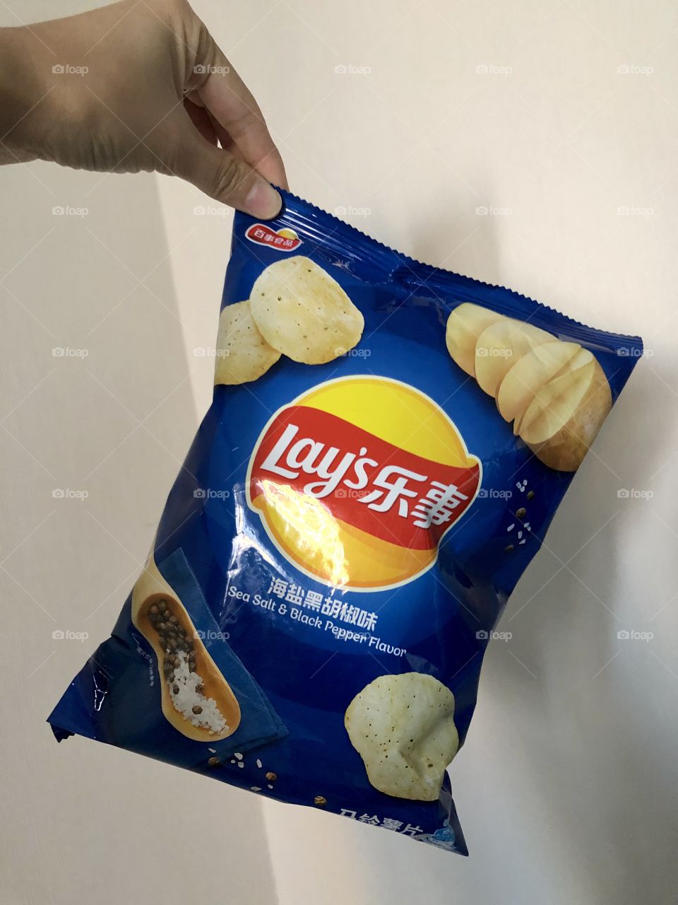 Lay’s chips holding by female hand,snack time