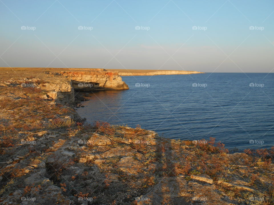 shadows people on a sunset sea shore summer travel