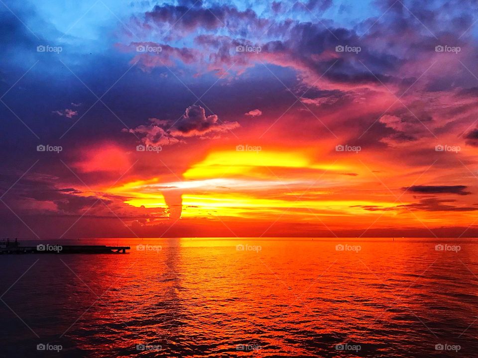 Beautiful sunset, dusk cloud, orange shade sky and reflection on the sea in thailand