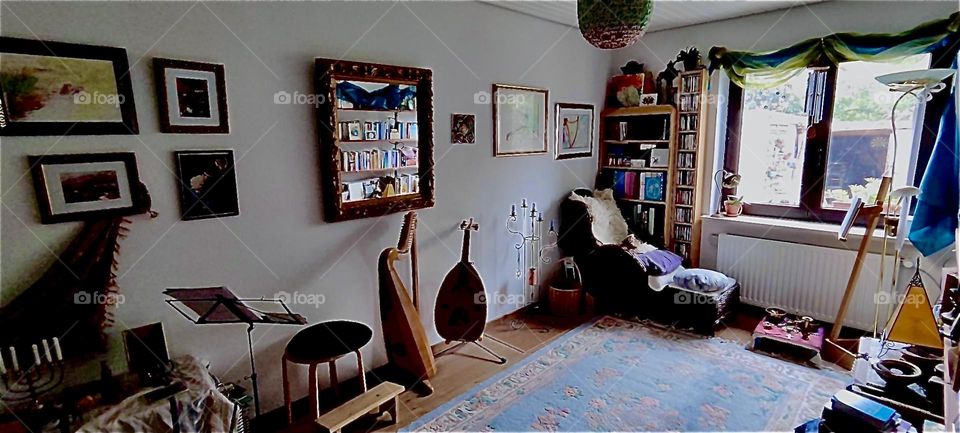 This is the music side of the exercise room and art studio in the beautiful house in “Bavaria”, Germany. Custom made instruments, a lute and a harp are standing by the wall beneath the mirror. 2023. Hypnotic Productions