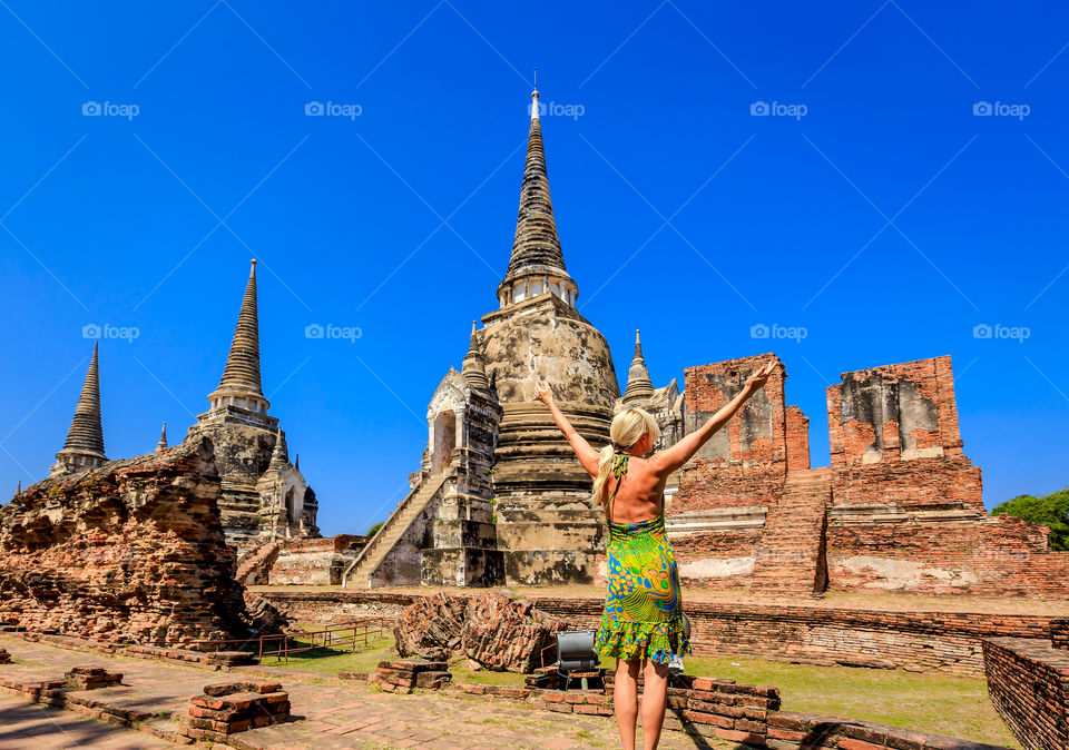 Female tourist enjoying in historical park in Ayutthaya, Thailand