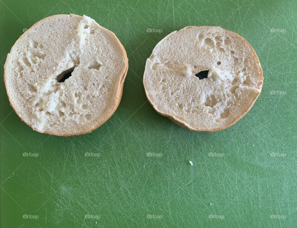 White and green - bagel slices on a green background 