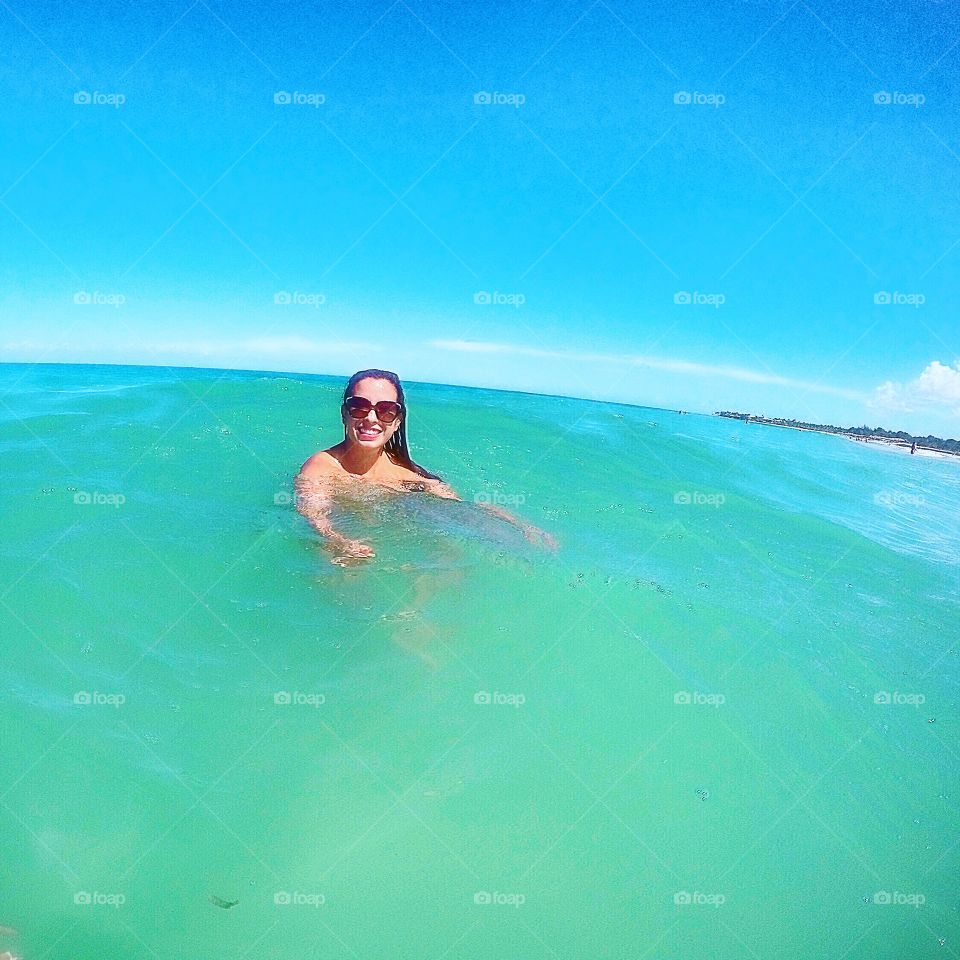 Happy woman swimming in sea