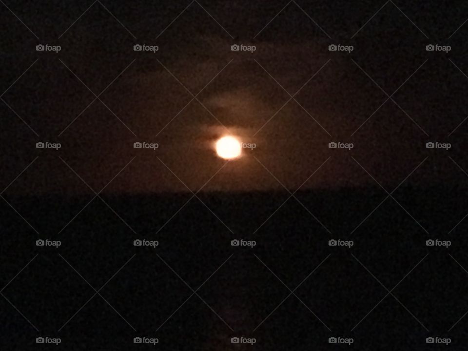 Moon rising full over Myrtle Beach and bright red in color 