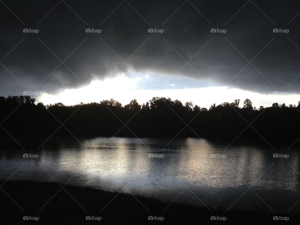 Storm Cloud Over Lake. I was out for a walk behind my house and noticed an ominous storm cloud hovering over our lake