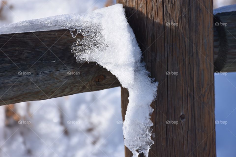 Snow on wooden fence