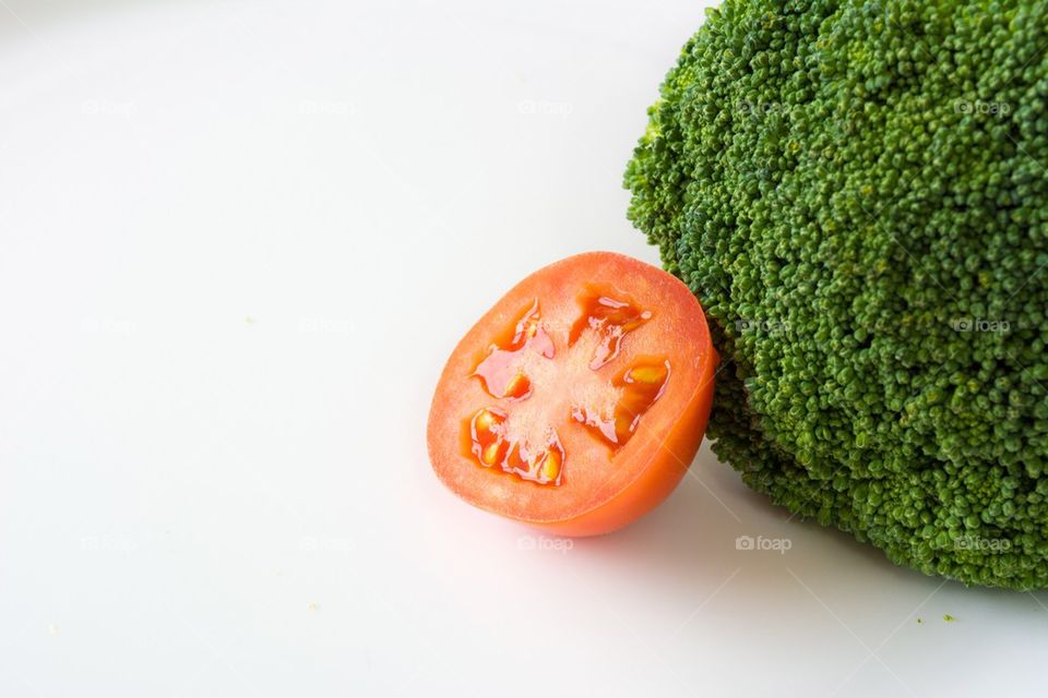 Broccoli and Tomato. Vegetables on white background.