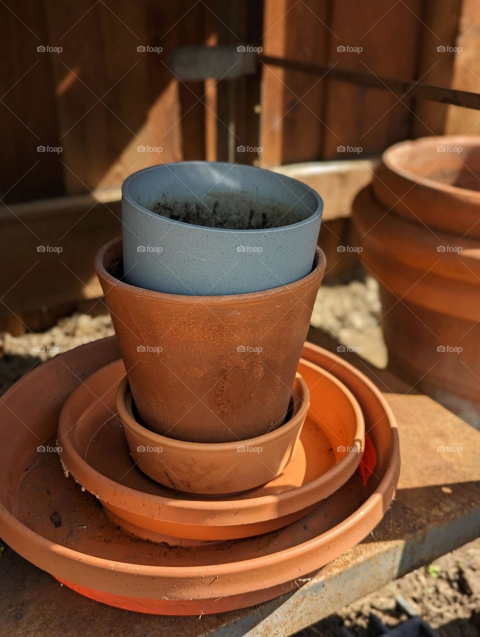terracotta potting pots and saucers waiting to be planted in this springtime at the potting station plant pots
