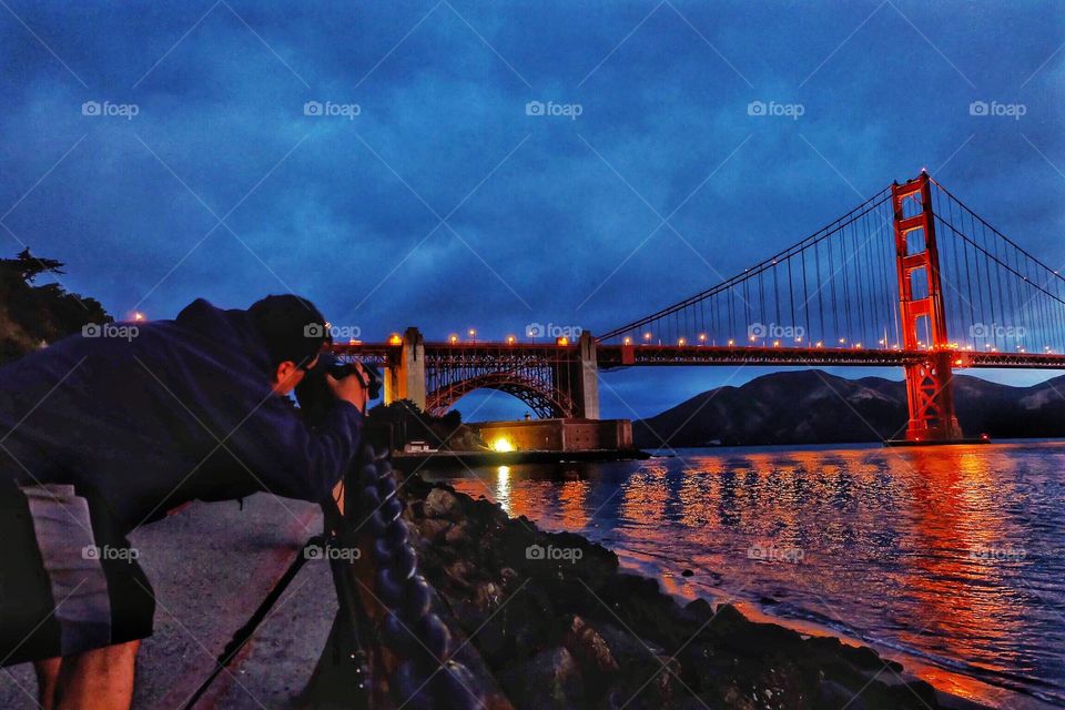 Photographer setting up his sunrise shot of the Golden Gate Bridge in San Francisco, Ca.