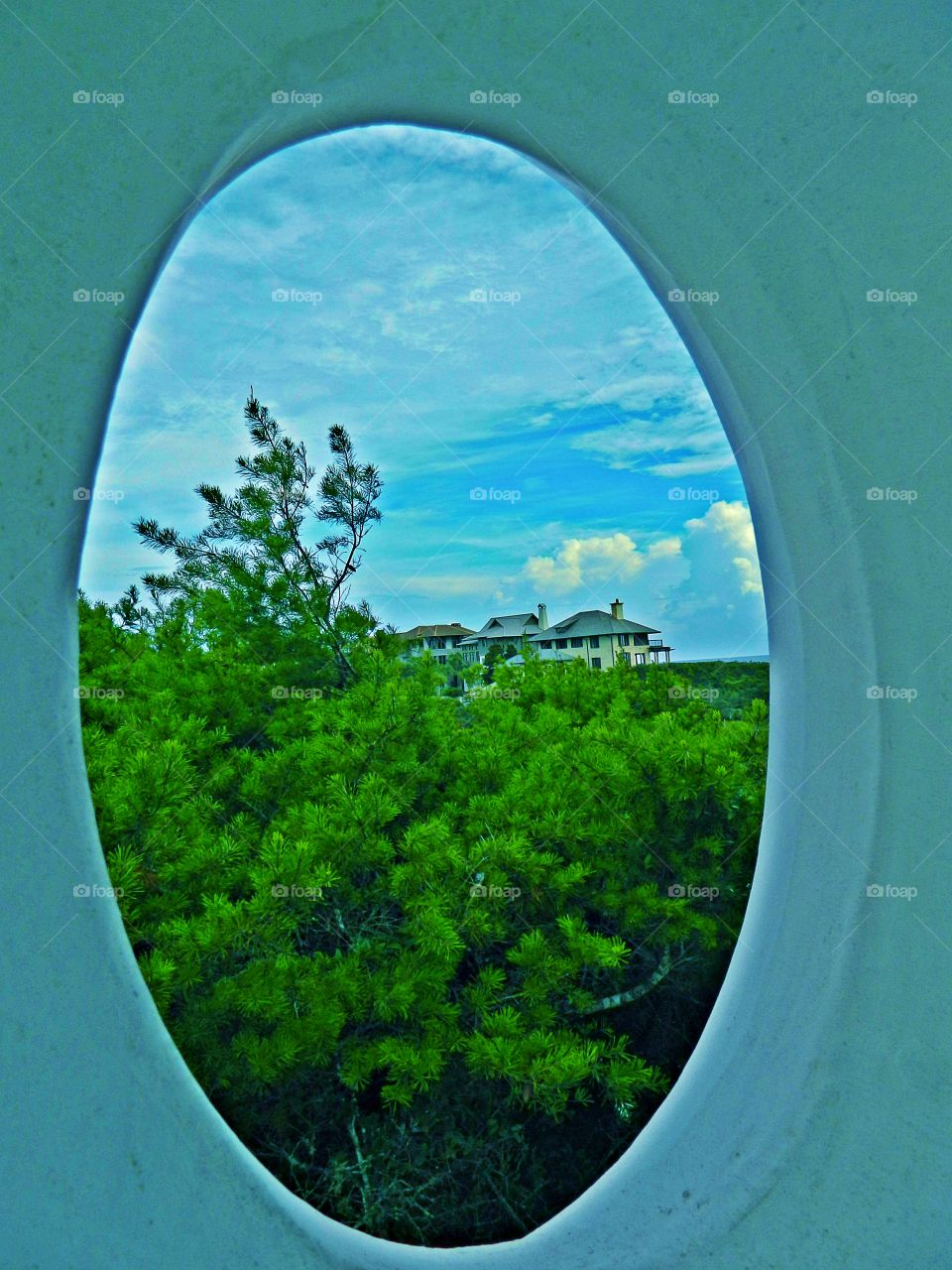 
Framing the oval photo of a landscape and distant houses draws focus to the subject in the photo by blocking other parts of the image with something in the scene