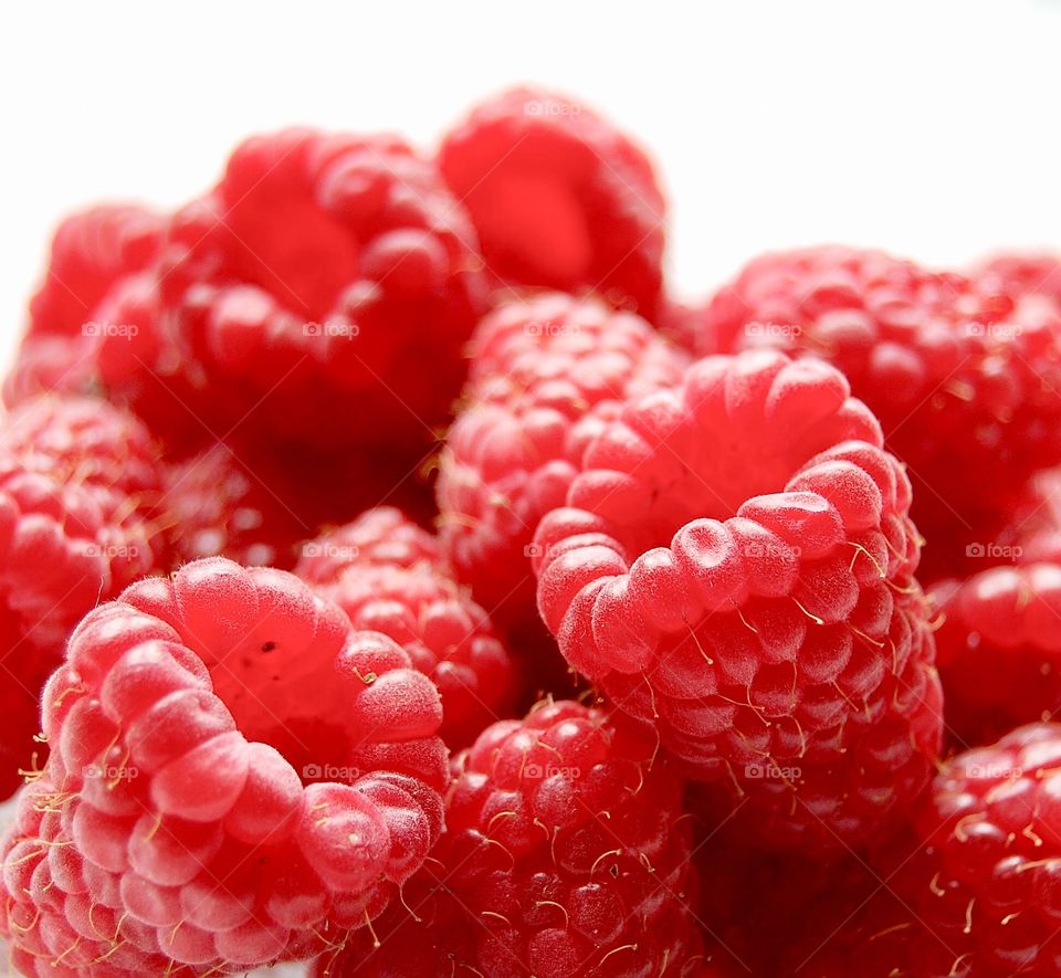 Close up of ripe juicy raspberries in a bowl