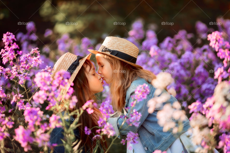 Little sisters in a blossom meadow 