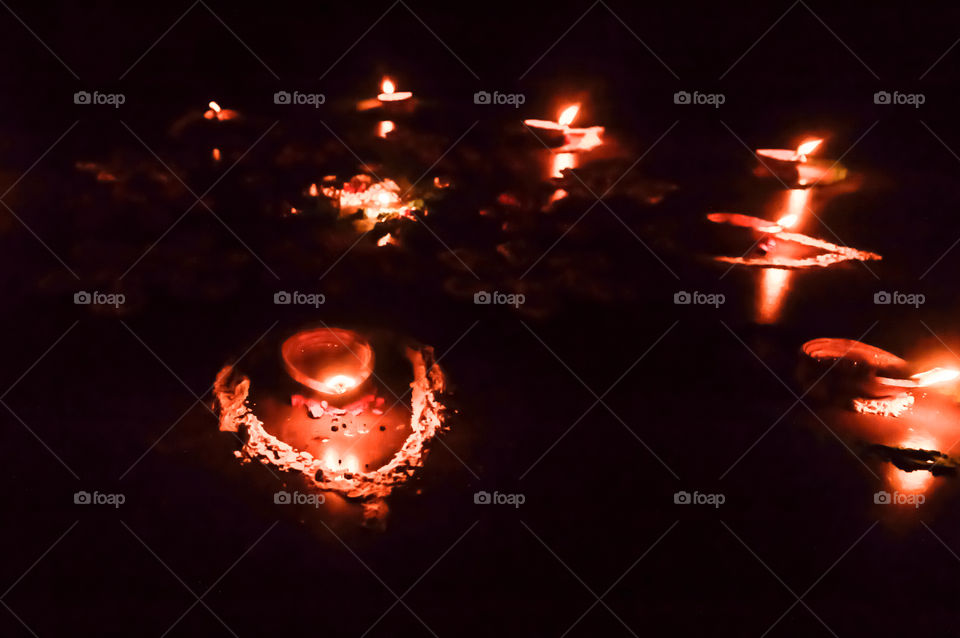 Group of decorated Diya- Oil Lamp lit in festival season of Diwali on black background. Concept of removing darkness.