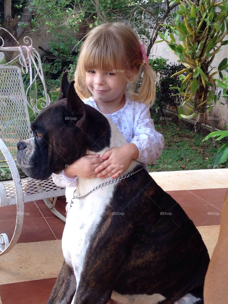 Child hugging dog