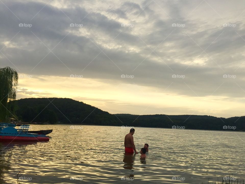 People in the Water at sunset