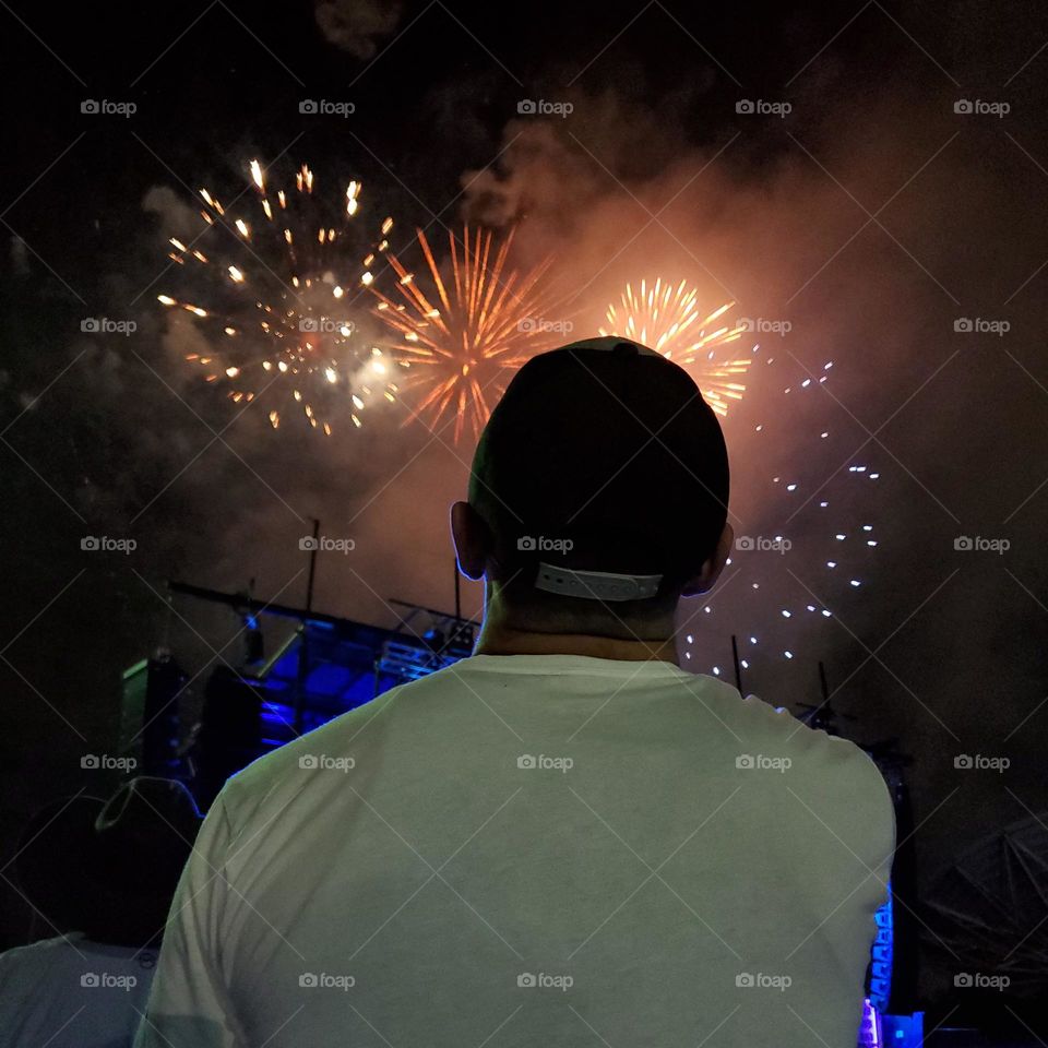 A man watching a fireworks show