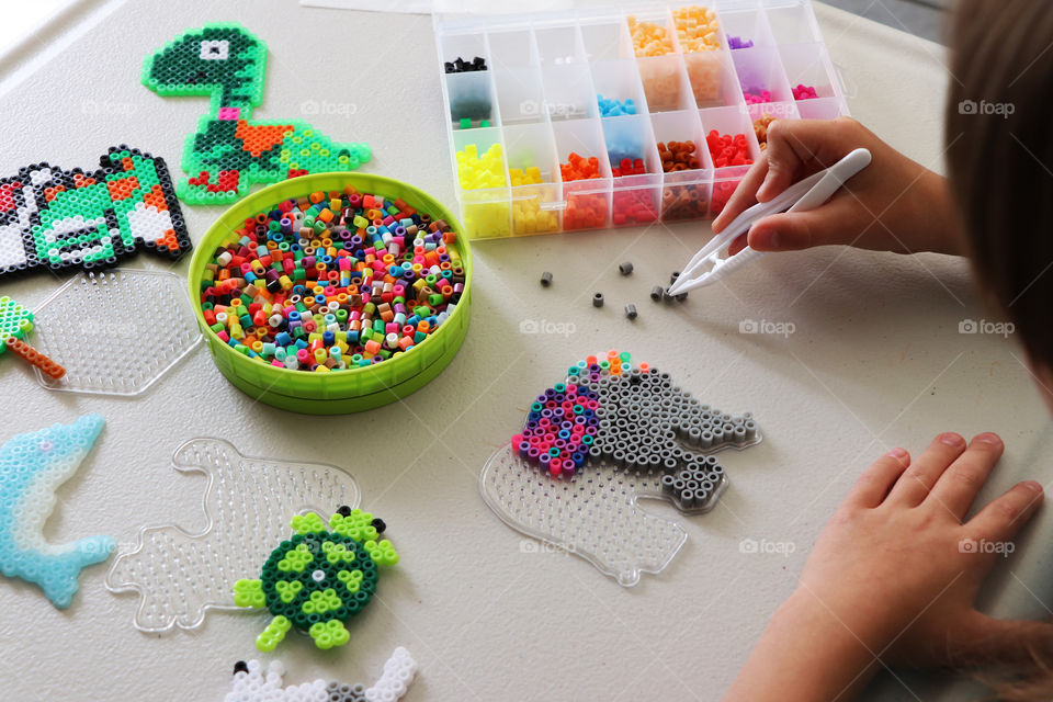 Child creating Fuse Bead picture