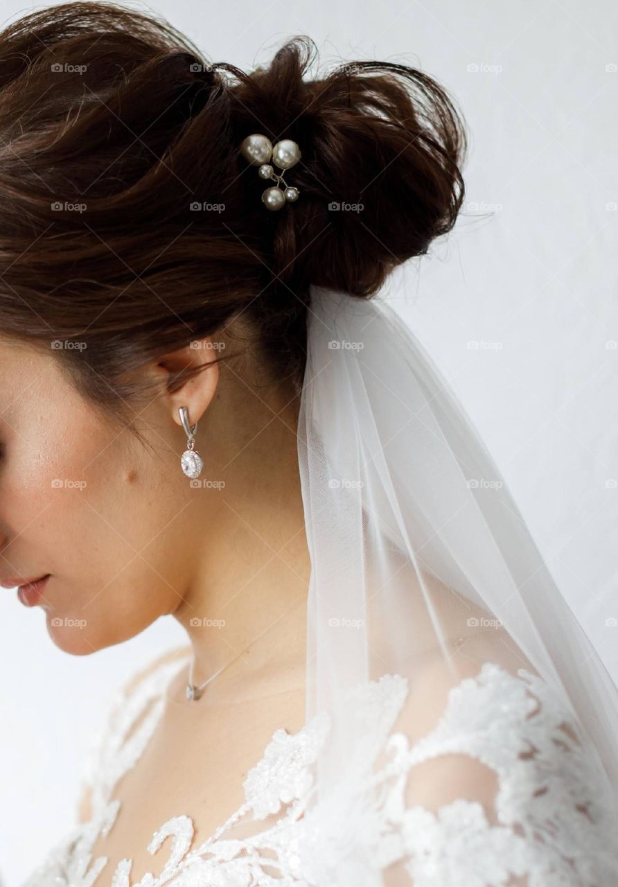 Silver earrings on the bride
