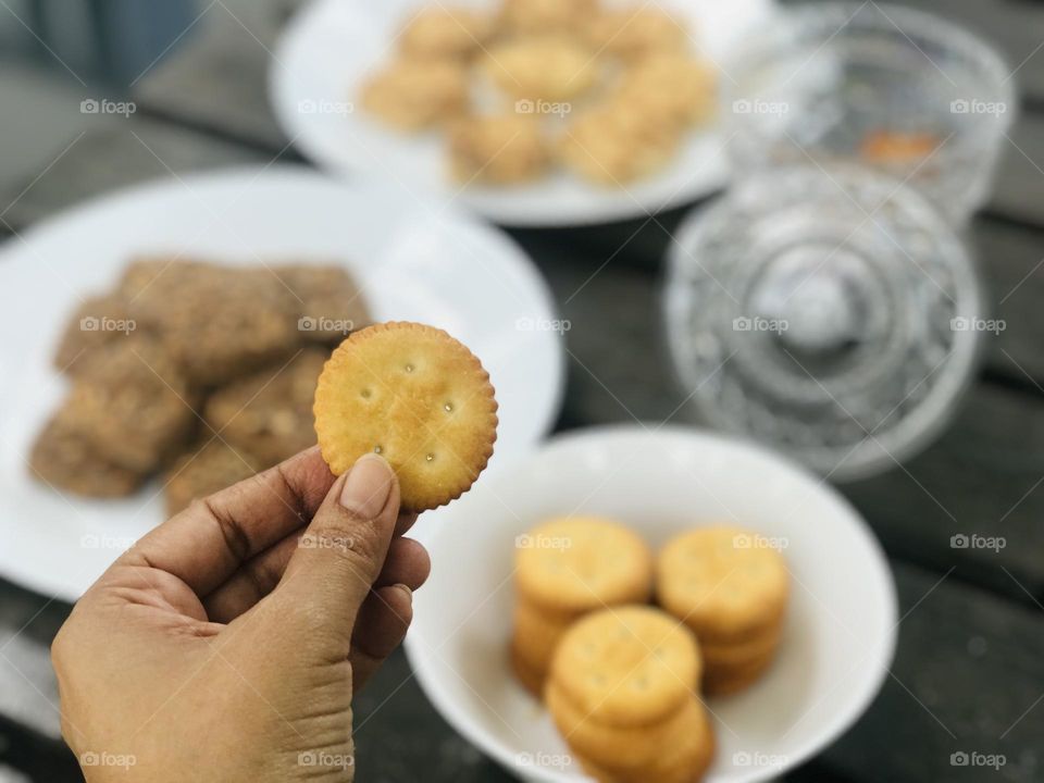 A salted Indian cookies and brown and white dry fruit cookies on table 