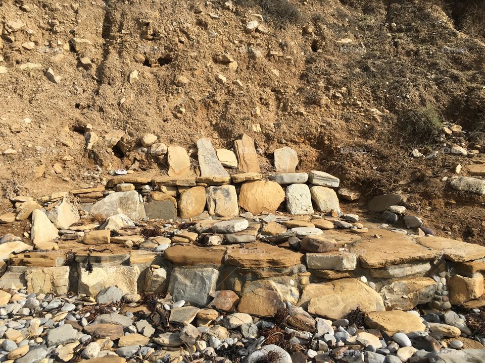 Stone bench on a Californian stone beach 
