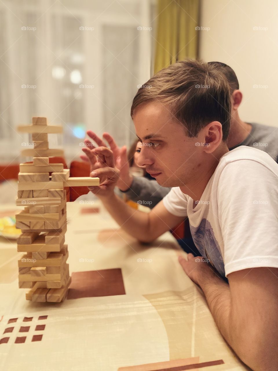 Man playing home game Jenga