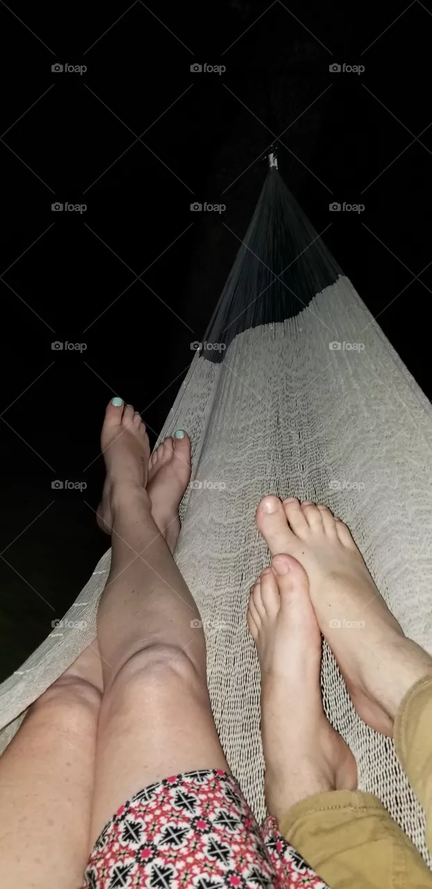 couple laying in hammock at night