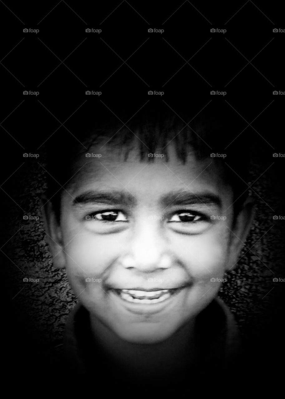 Smiles for everyone: my sweet nephew with his sweet smile ,  closeup with black and white image. 