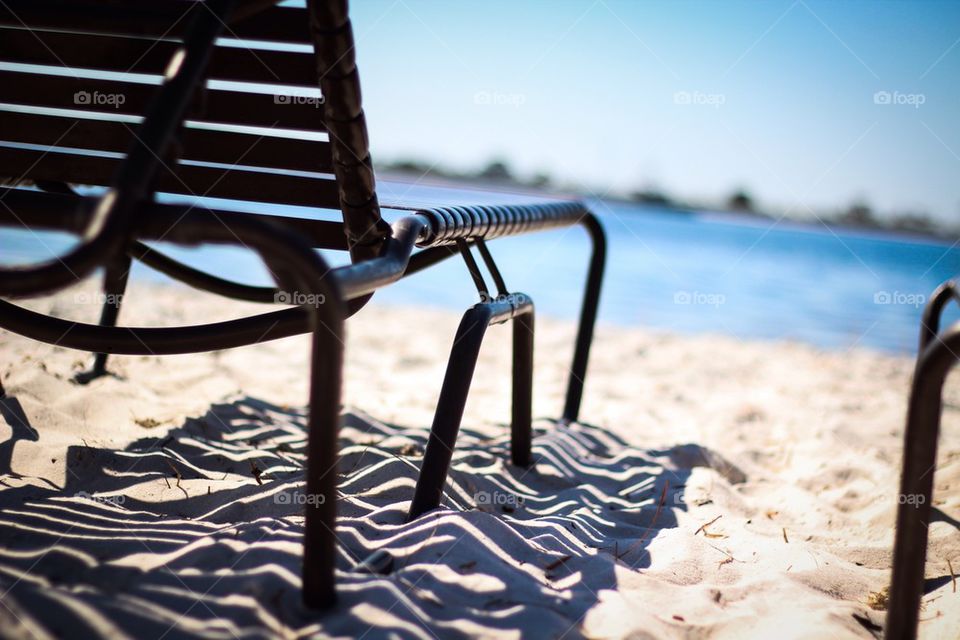 View of chairs on sand at beach