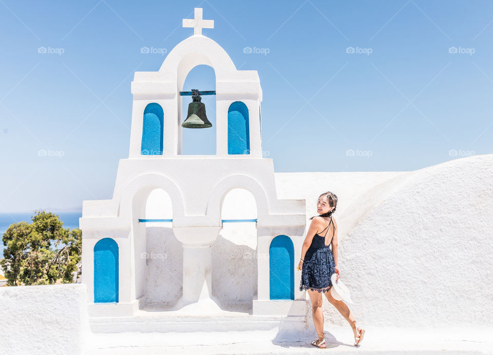 Young Tourist Woman On Vacation In Famous Greek Island Santorini
