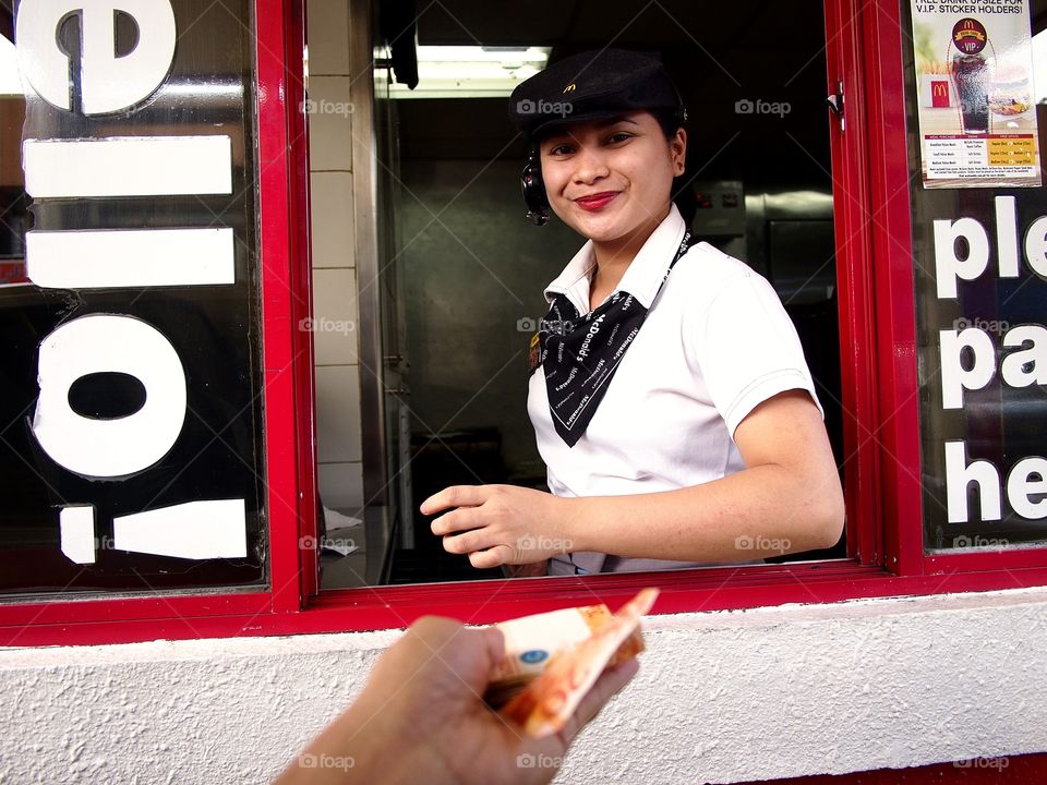 fastfood restaurant worker at a drive thru window