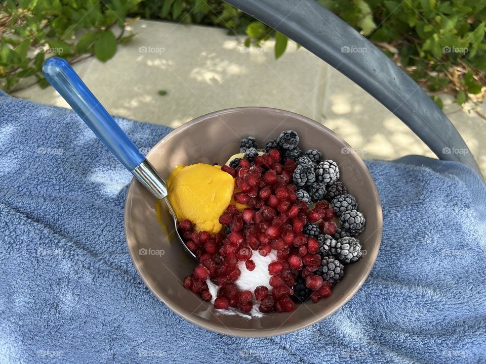 Ice cream and fruit on beach towel