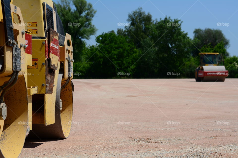 Excavator and levelling machine on a construction site