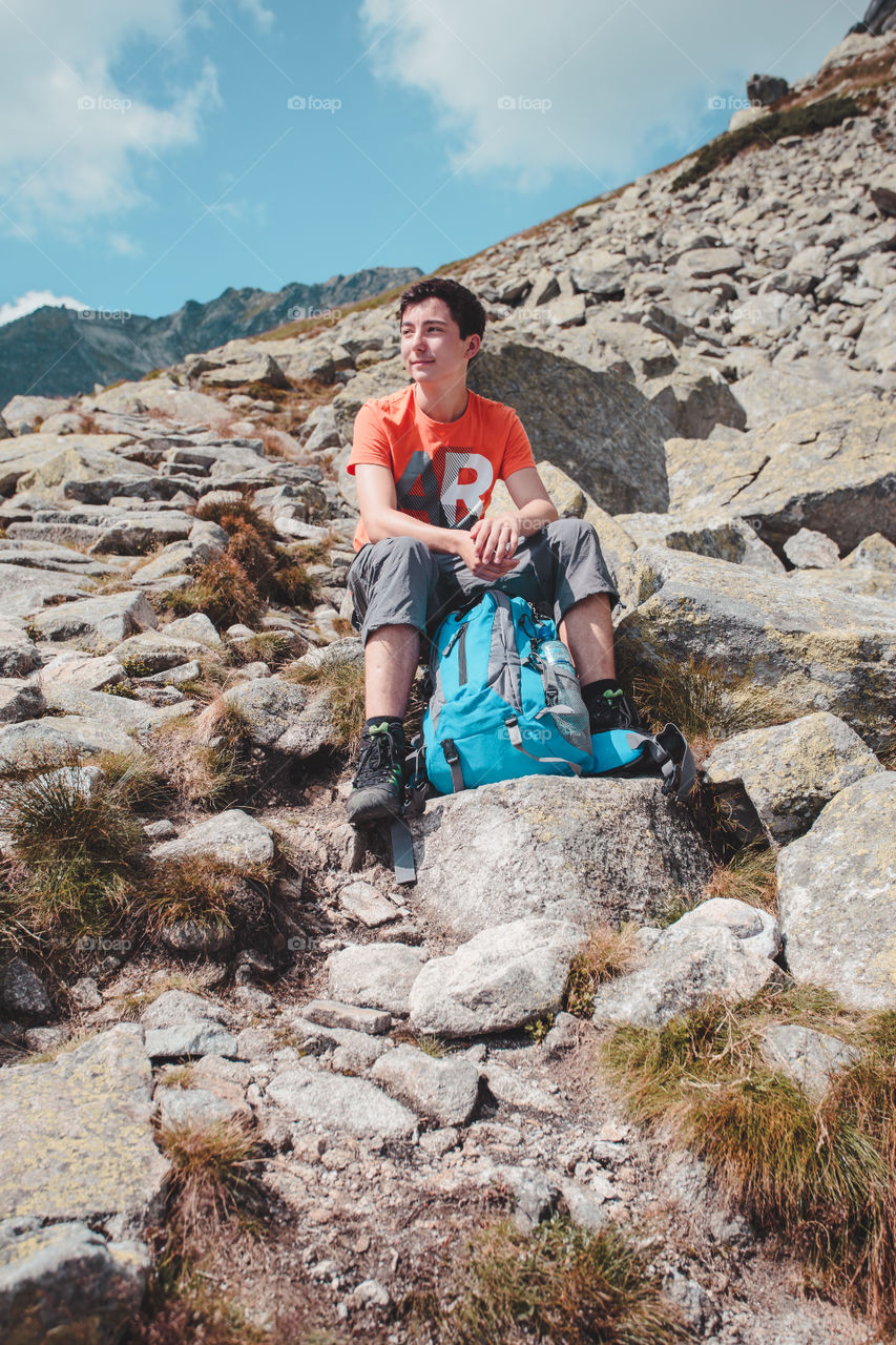 Boy resting on a rock in The Tatra Mountains