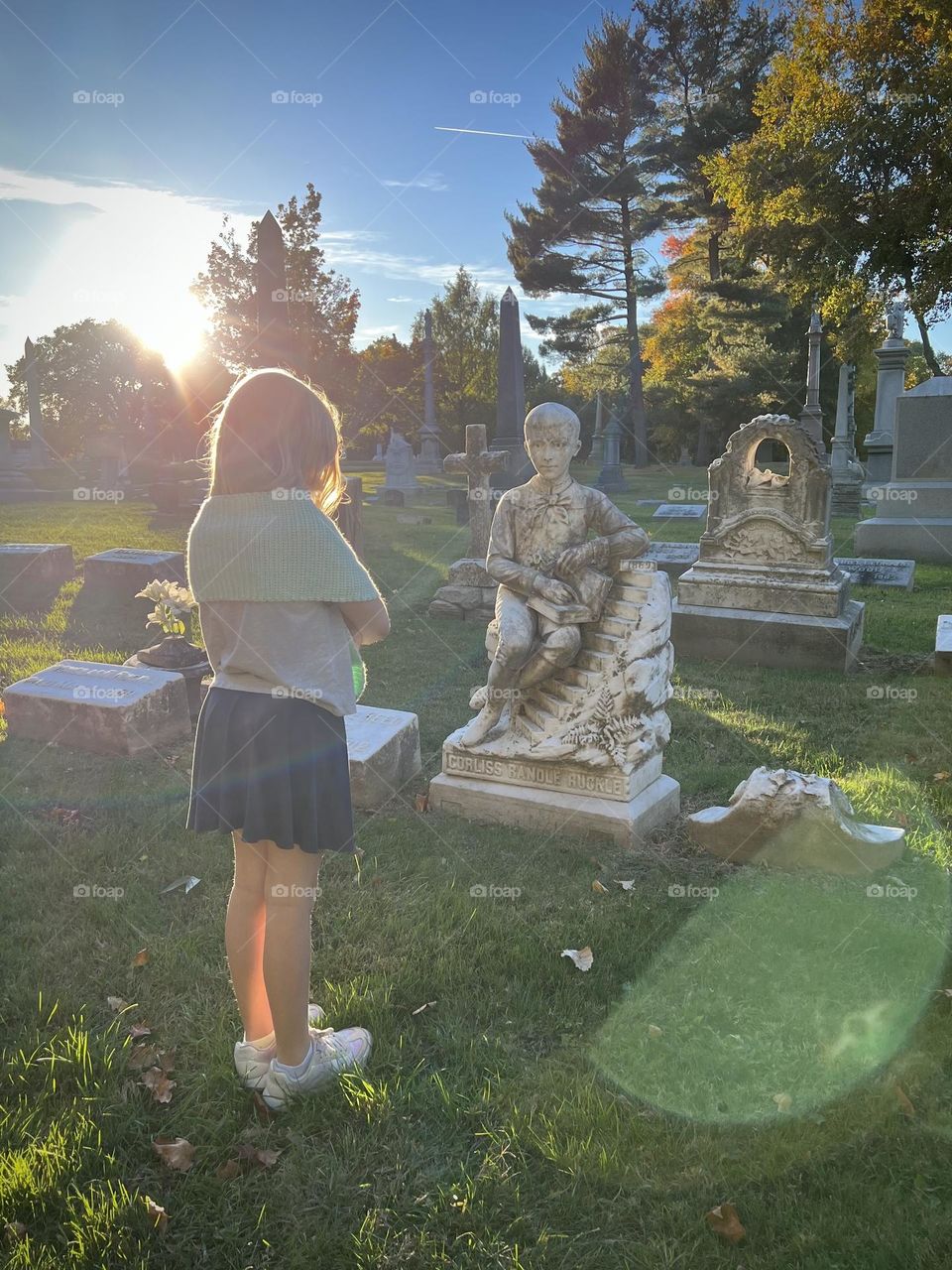 A beautiful girl visiting a little boy’s grave 