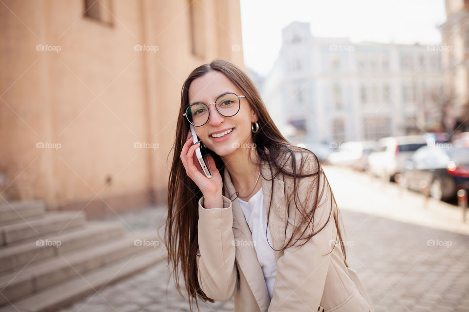 happy woman in the city center speaks by phone