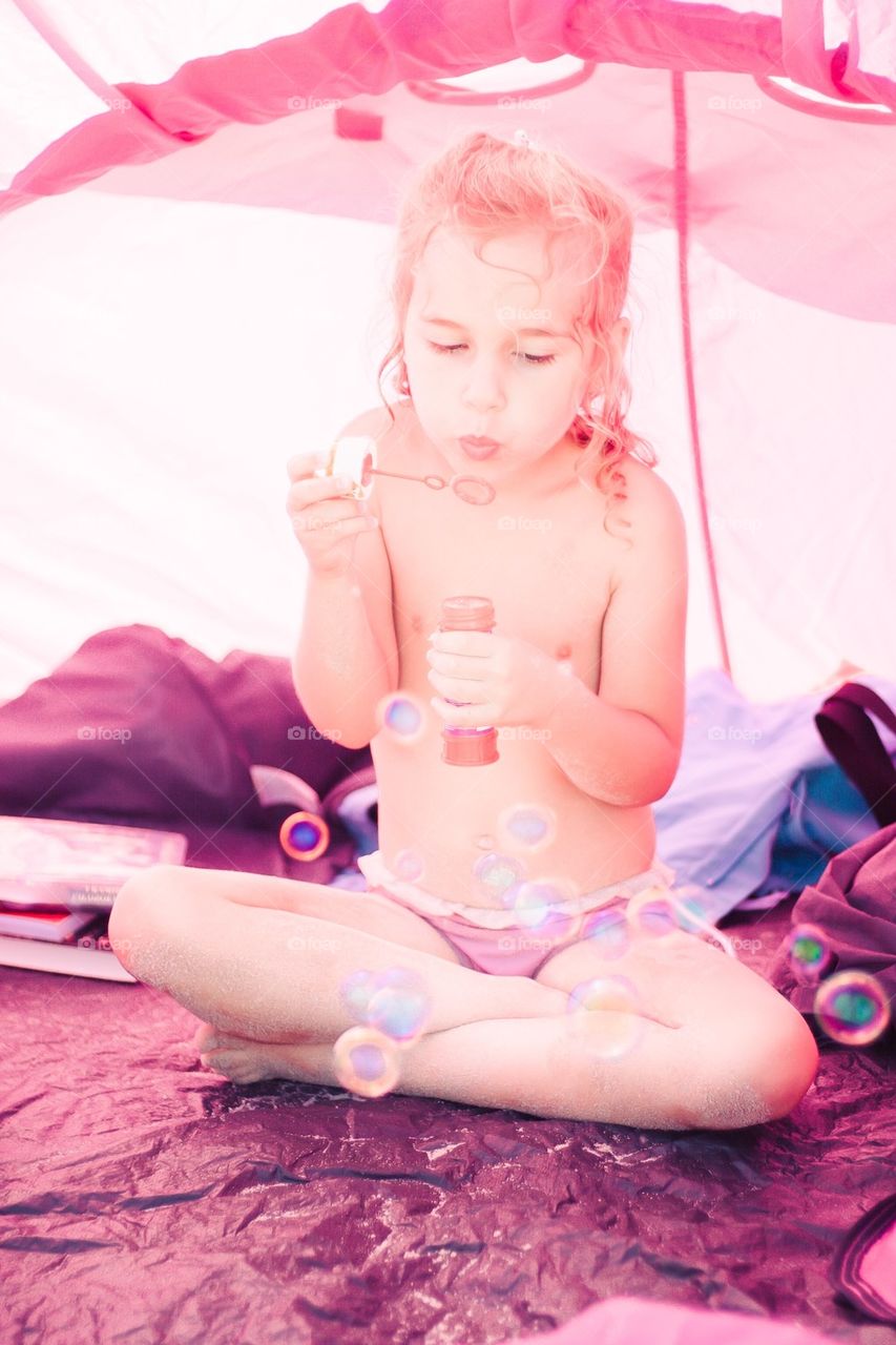 Girl making bubbles