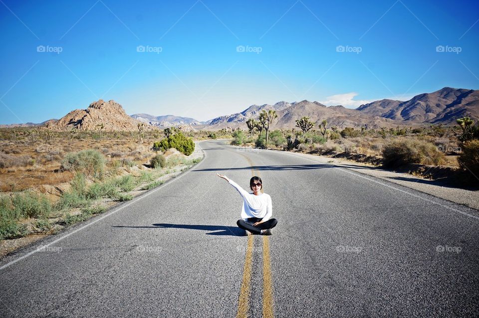 Woman sitting on the road