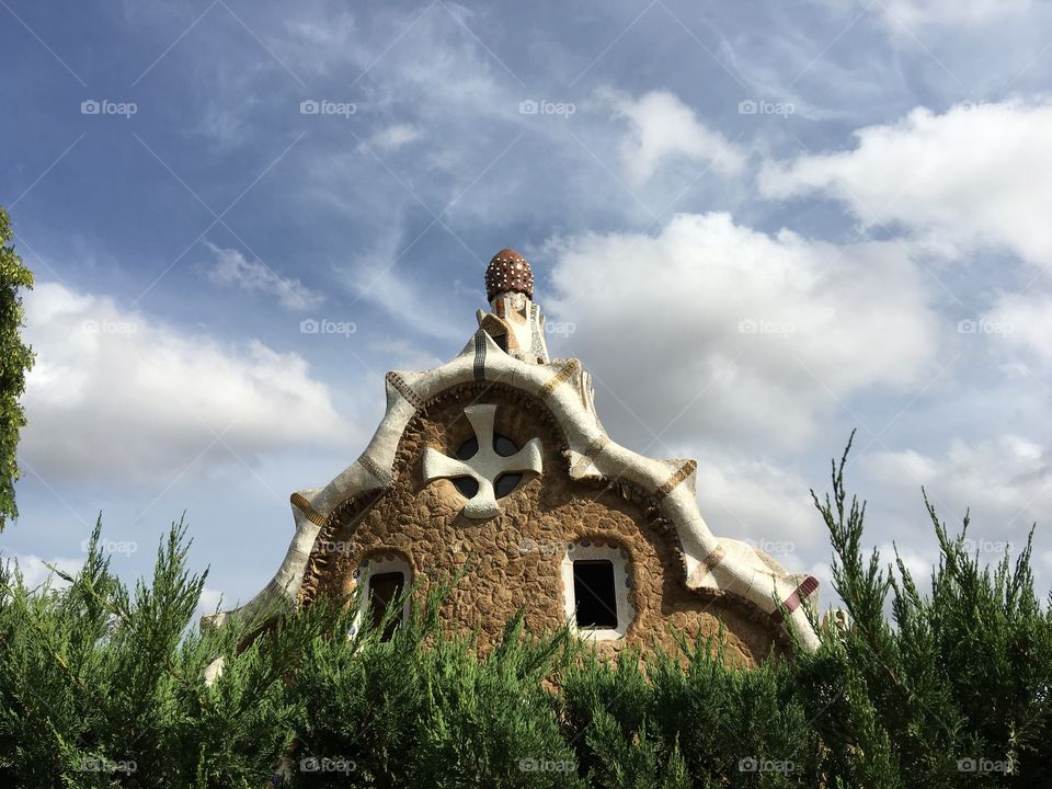 Gaudi house behind some hedges 