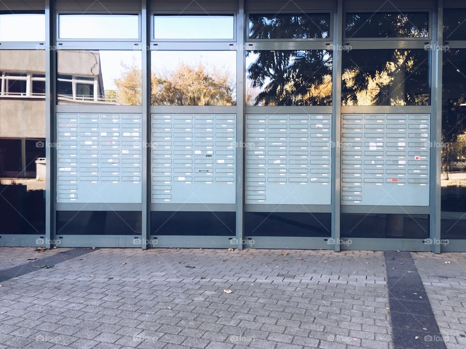 Lots of mail boxes in city. Huge array of letter boxes in large apartment building