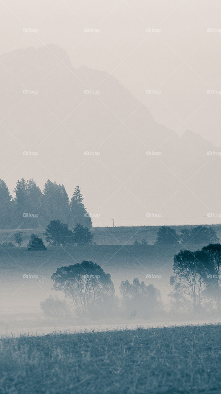 An inspiring mountain landscape. Tatry mountains in Slovakia. A beautiful wallpaper for smartphone screen. Monochrome blue abstract gradient with perspective.