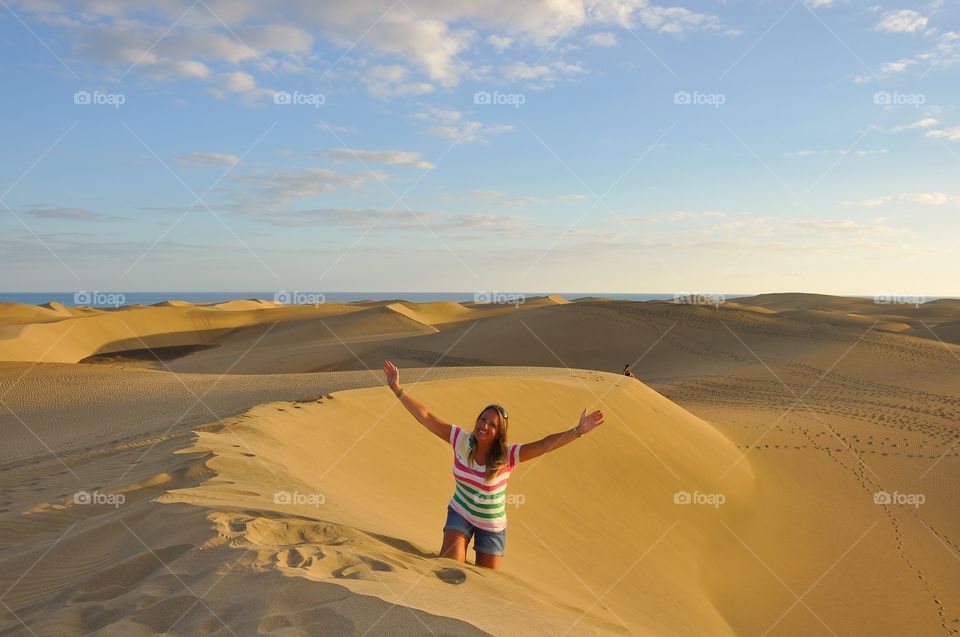 Happy woman standing on dessert