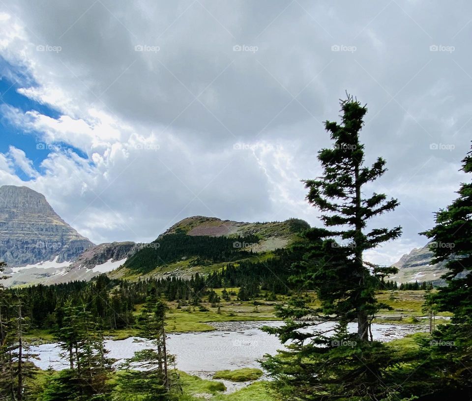 A mountain under a cloudy blue sky.