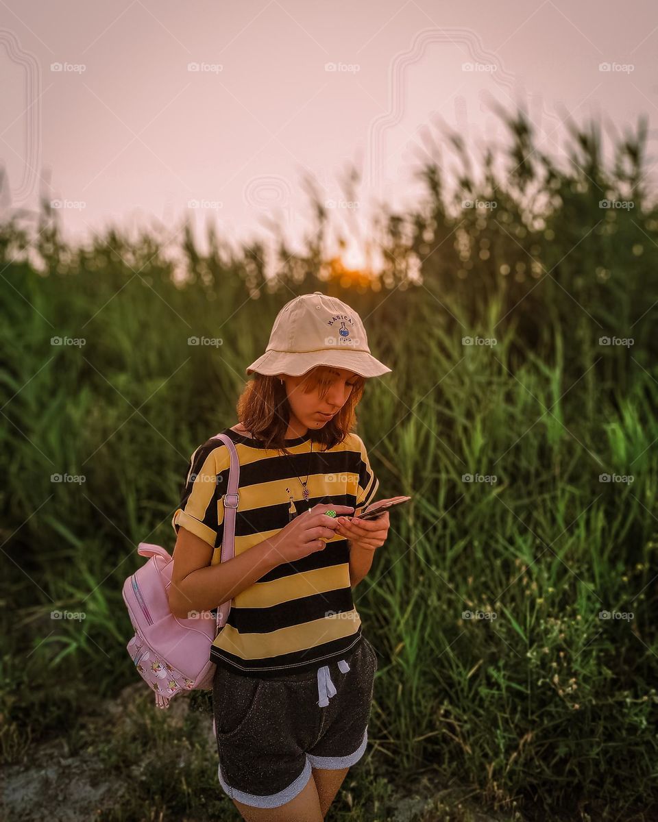 girl in summer clothes looking at the phone