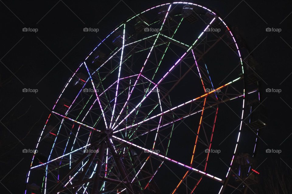 Bright Ferris wheel on a dark background