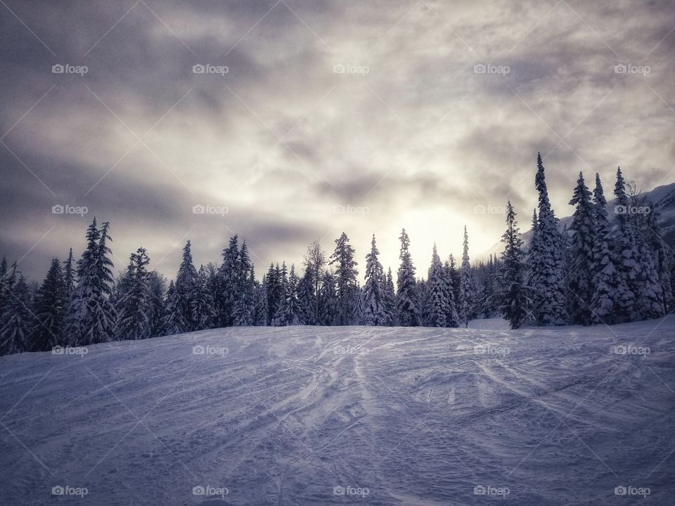 sunrise through the clouds on a mountain