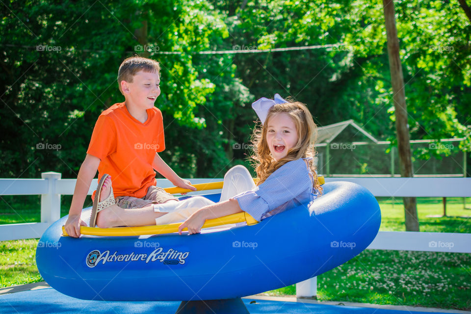 Boy and Girl Playing at a Playground Laughing 