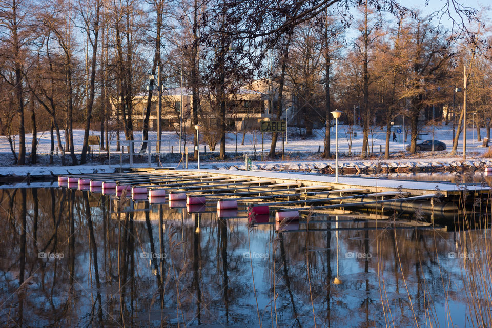 Snow covered boat docks in Helsinki, Finland on sunny December afternoon.