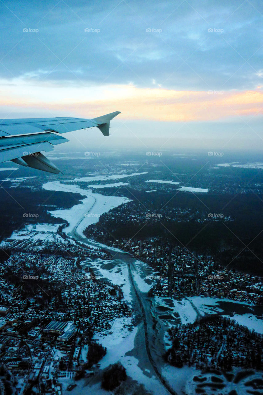 Aerial view of Berlin city showing snow on the lands and fog at the sky.