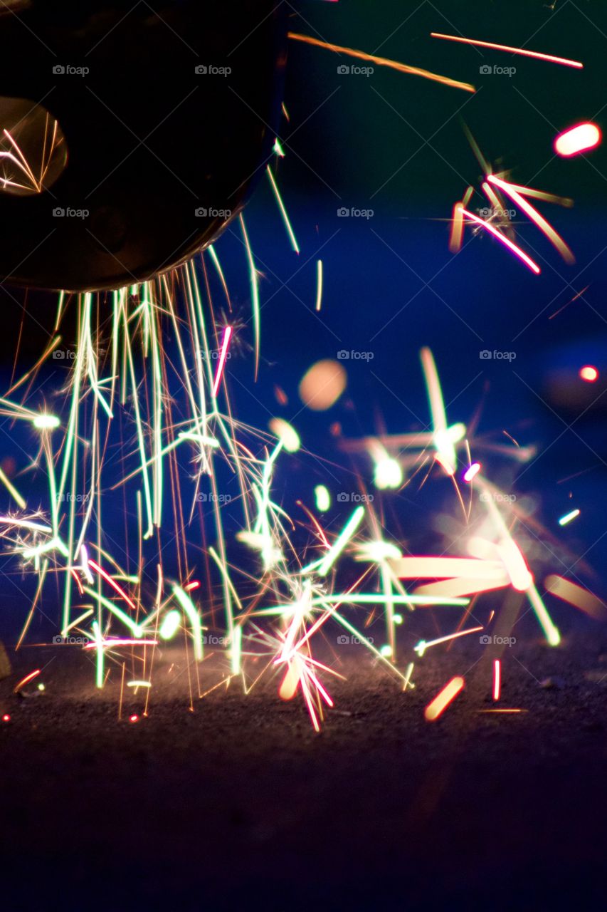 Closeup of sparks from a bench grinder being used on steel