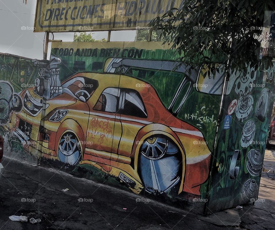 A big car graffiti in a dirty street.